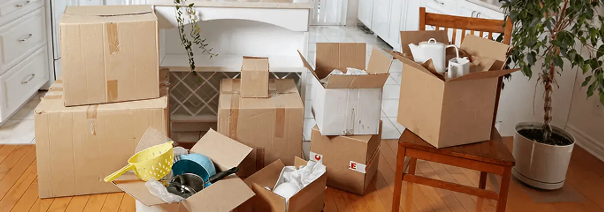 Packed moving boxes and household items in a kitchen before move-out or move-in cleaning, Providence, RI.